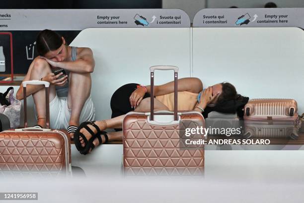 Passengers wait at Rome's Fiumicino airport during a strike by workers of some airline companies which forcibly cancelled hundreds of flights, in...