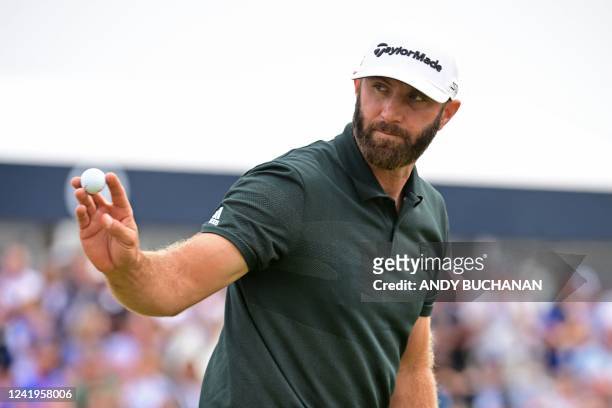Golfer Dustin Johnson reacts after making a putt on the 9th during his final round on day 4 of The 150th British Open Golf Championship on The Old...