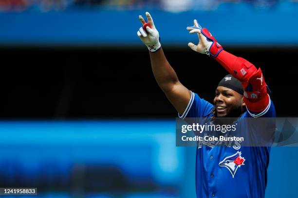 Vladimir Guerrero Jr. #27 of the Toronto Blue Jays celebrates beating the throw and hitting a single in the third inning of their MLB game against...