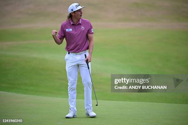 Australia's Cameron Smith celebrates after holing his final putt to make a birdie on the 18th green during his final round 64 on day 4 of The 150th...