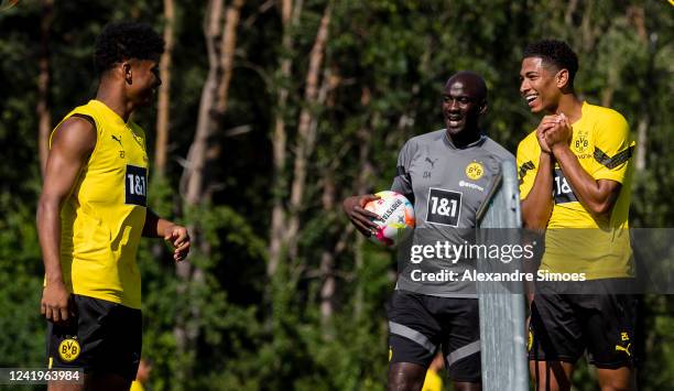 Karim Adeyemi, assistant coach Otto Addo and Jude Bellingham of Borussia Dortmund during a training session at the Borussia Dortmund Training Camp on...