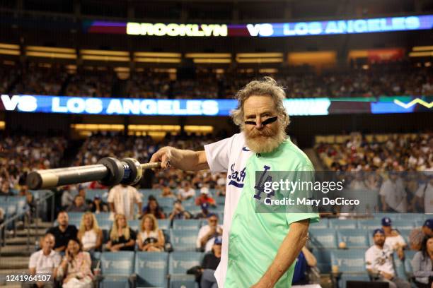 Bryan Cranston holds up a bat during the MGM All-Star Celebrity Softball Game at Dodger Stadium on Saturday, July 16, 2022 in Los Angeles, California.