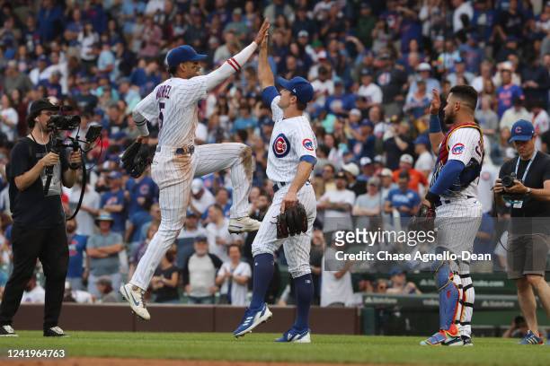 Christopher Morel of the Chicago Cubs high-fives David Robertson of the Chicago Cubs after the Chicago Cubs defeated the New York Mets at Wrigley...