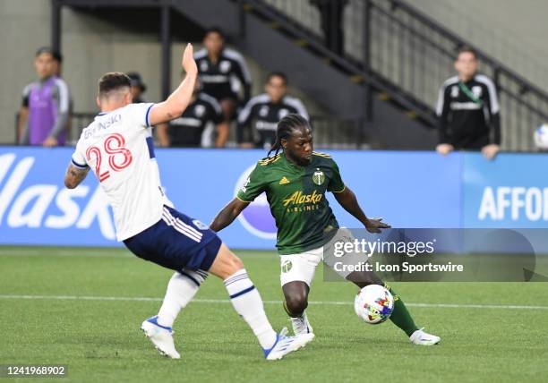 Portland Timbers midfielder Yimmi Chara controls the ball against Vancouver Whitecaps FC defender Jake Nerwinski during a match between the Portland...