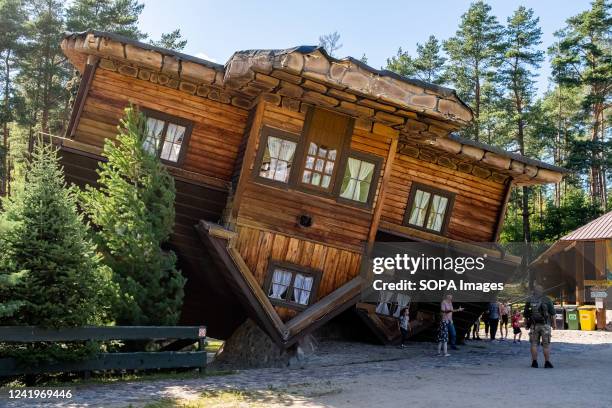 View of an upside down house in Szymbark. The Upside Down House in Szymbark is an inverted wooden house where the visitors walk on the ceilings and...