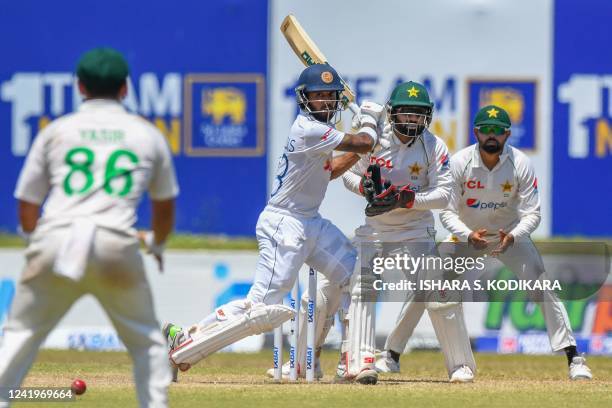 Sri Lanka's Kusal Mendis plays a shot as Pakistans wicketkeeper Mohammad Rizwan watches during the third day of play of the first cricket Test match...