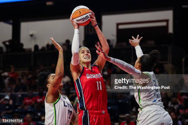 Elena Delle Donne of the Washington Mystics goes to the basket against Damiris Dantas and Aerial Powers of the Minnesota Lynx during the first half...