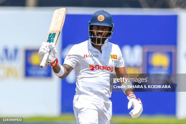 Sri Lanka's Kusal Mendis celebrates after scoring a half century during the third day of play of the first cricket Test match between Sri Lanka and...