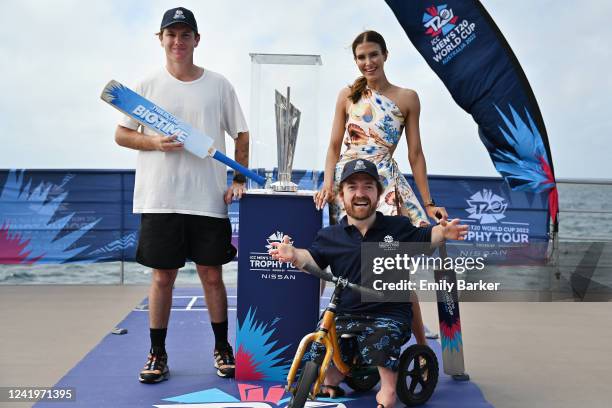 Adam Zampa, Erin Holland and Grant Scooter Patterson with the tournament trophy aboard the Reef Magic Pontoon during the ICC Men's T20 World Cup...