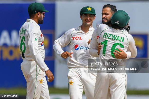 Pakistans Mohammad Nawaz celebrates with teammates after taking the wicket of Sri Lanka's Niroshan Dickwella during the third day of play of the...