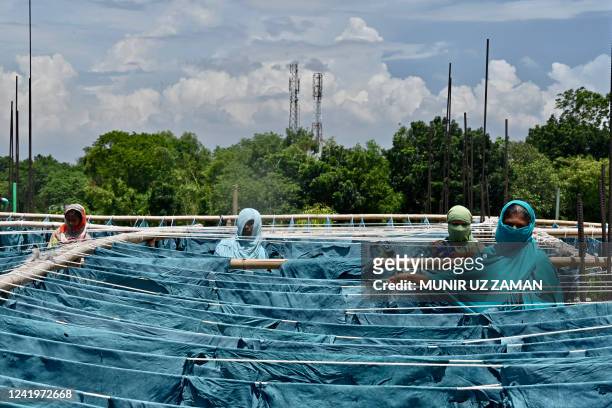 Workers dry hide from sacrificed cattle in the Eid al-Adha Muslim festival, at a tannery in Savar on July 18, 2022.