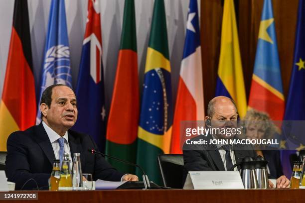 Egypt's President Abdel Fattah al-Sisi addresses delegates as German Chancellor Olaf Scholz looks on during the 13th Petersberg Climate Dialogue...