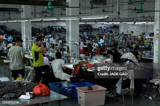 Workers make clothes at a garment factory that supplies SHEIN, a cross-border fast fashion e-commerce company in Guangzhou, in China's southern...