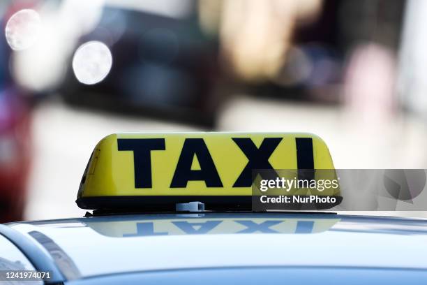 Taxi sign is seen on a car in Krakow, Poland on July 18, 2022.