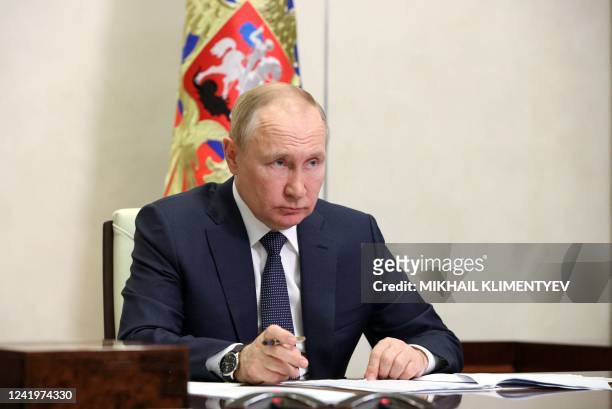 Russian President Vladimir Putin chairs a meeting of the Presidential Council for Strategic Development and National Projects via a video link at the...