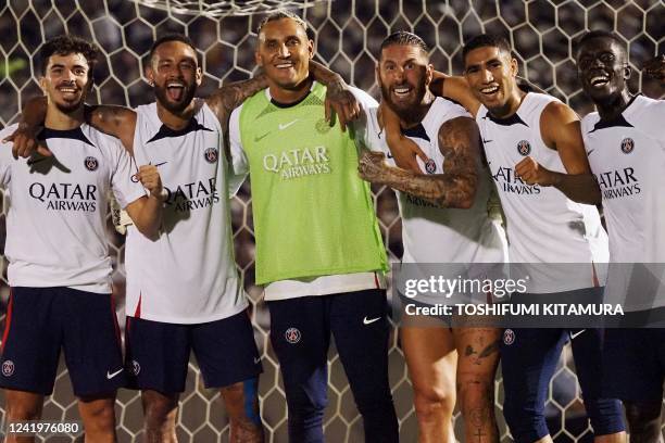 France's Paris Saint-Germain's Sergio Ramos , Neymar Jr , Keylor Navas and other players celebrate to win the mini game during their training session...