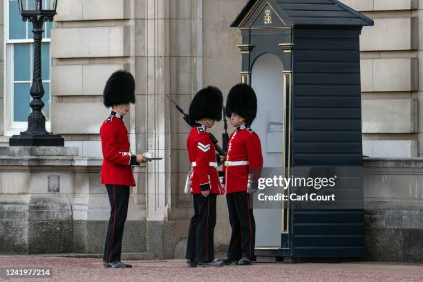 Guardsman is brought water as he stands sentry outside Buckingham Palace on July 18, 2022 in London, England. Temperatures were expected to hit 40C...