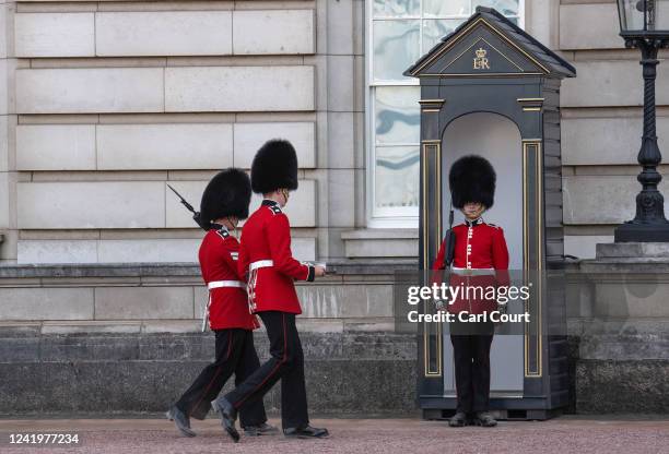 Guardsman is brought water as he stands sentry outside Buckingham Palace on July 18, 2022 in London, England. Temperatures were expected to hit 40C...