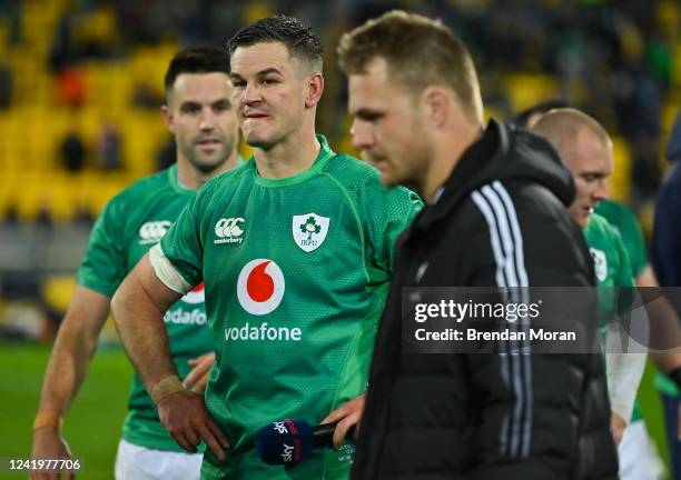 Wellington , New Zealand - 16 July 2022; Ireland captain Jonathan Sexton looks on as New Zealand captain Sam Cane walks to be inteviewed after the...