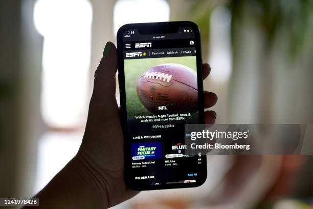 The ESPN+ NFL homescreen on a smartphone in the Brooklyn borough of New York, US, on Monday, July 18, 2022. Walt Disney Co.'s ESPN will raise the...