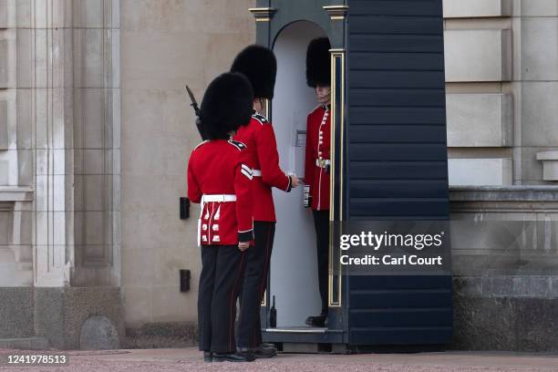 Guardsman is brought water as he stands sentry outside Buckingham Palace on July 18, 2022 in London, England. Temperatures were expected to hit 40C...