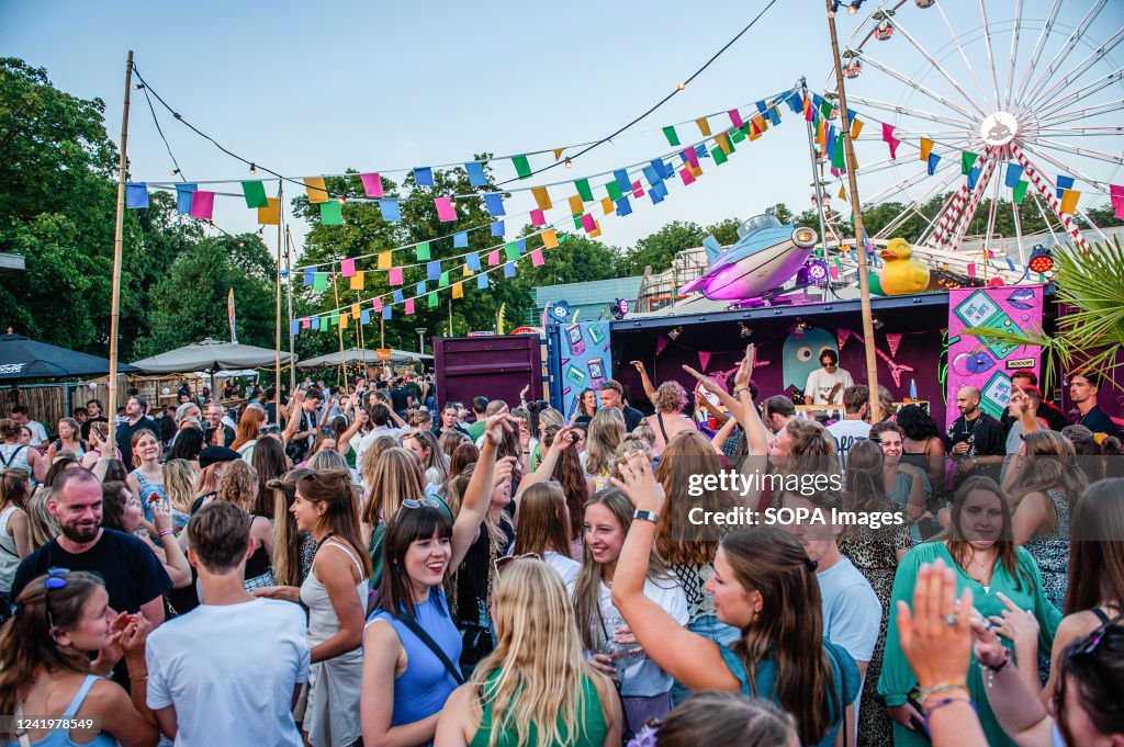 People are seen dancing and raising their hands in the air...