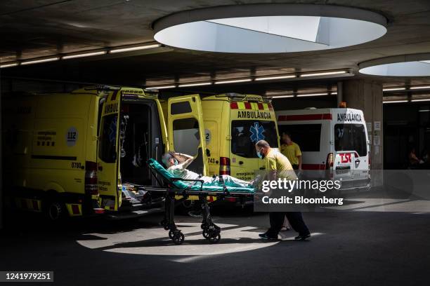 Paramedics bring a patient to the emergency room at Hospital del Mar during a heat wave in Barcelona, Spain, on Monday, July 18, 2022. The heat wave...