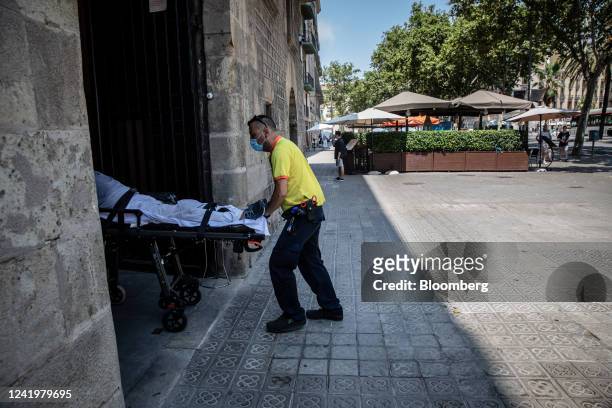 Paramedic moves a patient to an ambulance during a heat wave in Barcelona, Spain, on Monday, July 18, 2022. The heat wave killed 360 people dead in...