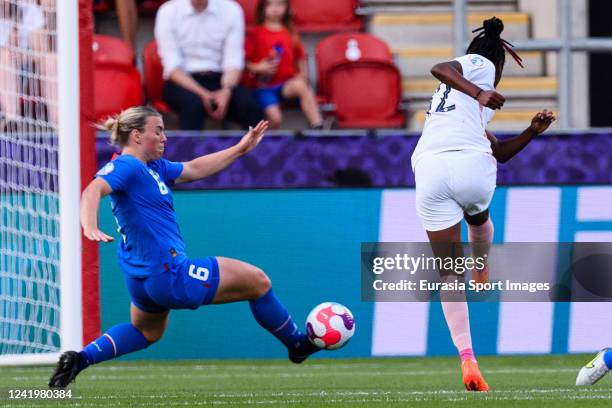 Melvine Malard of France attempts a kick while being defended by Ingibjorg Sigurdardóttir of Iceland during the UEFA Women's Euro England 2022 group...