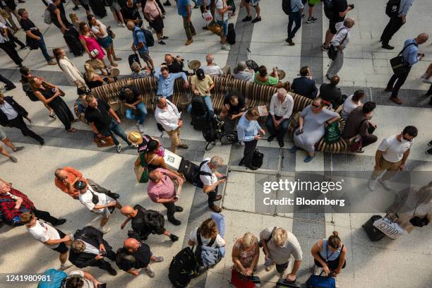 Travelers wait at Liverpool Street railway station during a heatwave in London, UK, on Monday, July 18, 2022. Extreme heat could lead to power...