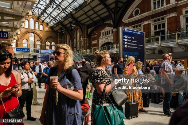 Travelers wait at Liverpool Street railway station during a heatwave in London, UK, on Monday, July 18, 2022. Extreme heat could lead to power...