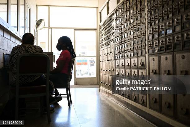 An applicant applies for a job on laptop during a job fair hiring new postal workers and mail carrier assistants at a United States Postal Service...