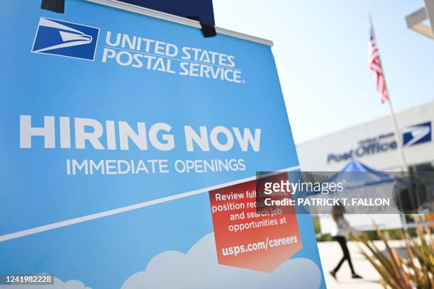Hiring now signage is displayed during a job fair hiring new postal workers and mail carrier assistants at a United States Postal Service post office...