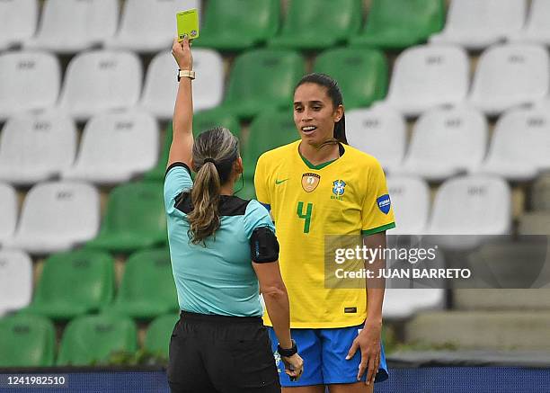 Paraguayan referee Zulma Quiñonez shows the yellow card to Brazil's Rafaelle as she conducts the Conmebol 2022 women's Copa America football...
