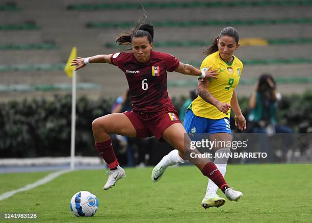 Venezuela's Deyna Castellanos and Brazil's Debinha vie for the ball during their Conmebol 2022 women's Copa America football tournament match at the...