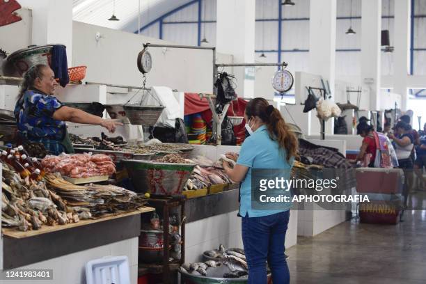 Business owner sells fish at a local market on July 18, 2022 in La Libertad, El Salvador. According to El Salvador's Ministry of Health more than 11...