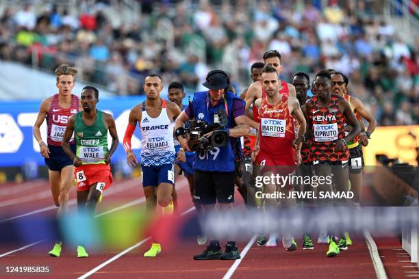 Television cameraman films as runners compete in the men's 3000m steeplechase final during the World Athletics Championships at Hayward Field in...