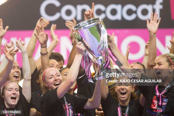 S players celebrate with the trophy after winning the 2022 Concacaf women's championship final football match against Canada, at the BBVA Bancomer...