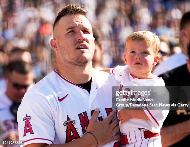 Los Angeles, CA Mike Trout of the Los Angeles Angeles holds his son Beckham Trout during the National Anthem prior to the first round of the All-Star...