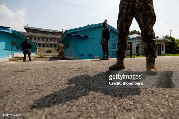 South Korean and United Nations Command soldiers stand guard next to the United Nations Command Military Armistice Commission conference buildings at...