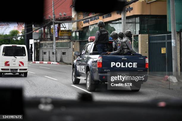 Police patrol on a street in Yangon on July 19 on the 75th Martyrs' Day that marks the anniversary of the assassination of independence leaders...