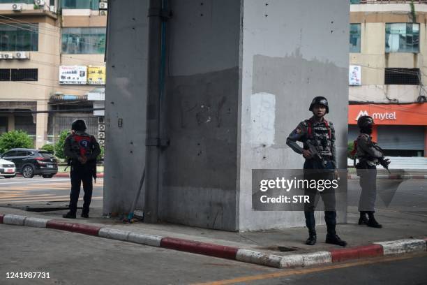 Members of the Myanmar security forces stand guard on a street in Yangon on July 19 on the 75th Martyrs' Day that marks the anniversary of the...