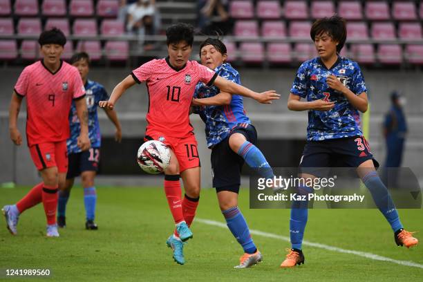 Soyun Ji of South Korea keeps the ball under the pressure from Ruka Norimatsu of Japan during the EAFF E-1 Football Championship match between Japan...