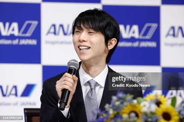 Two-time Olympic figure skating gold medalist Yuzuru Hanyu smiles during a press conference in Tokyo on July 19, 2022. The 27-year-old announced his...