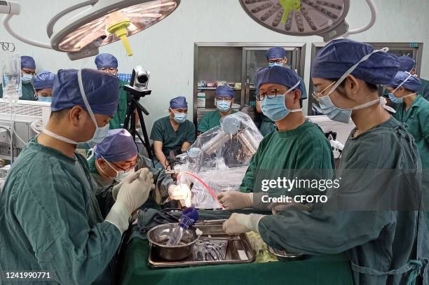 Doctors perform the first 5G-guided robotic arm precision neurosurgery in Shaoxing, East China's Zhejiang Province, July 18, 2022. It is understood...