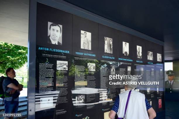 People read information about the victims on a board as they visit the memorial site"'Erinnerungsort Olympia-Attentat" at the Olympic Park in Munich,...