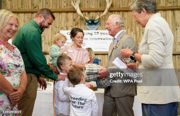 Prince Charles, Prince of Wales is given a gift by Dusty and George Smith, sons of Matt and Pip Smith, as he attends the Innovative Farmers 10th...