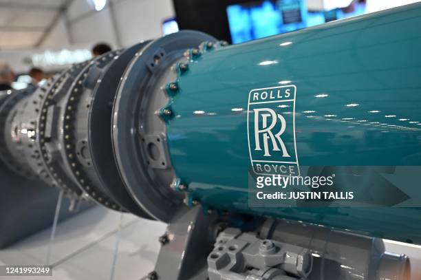 Logo is pictured on a component for an aircraft engine at the Rolls Royce stand at the Farnborough Airshow, in Farnborough, on July 19, 2022.