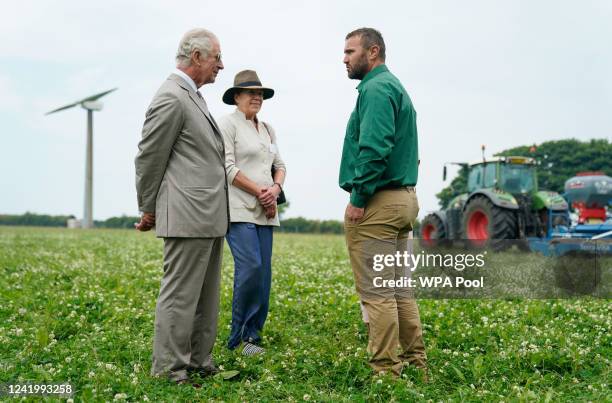 Prince Charles, Prince of Wales chats with Matt Smith as they walk through herbal leys as he attends the Innovative Farmers 10th anniversary at...