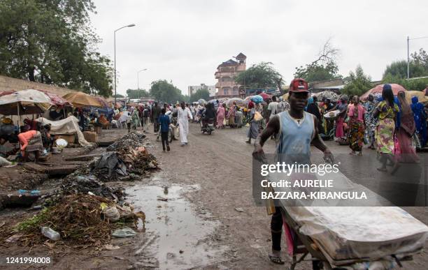 Man pushes a cart in the central alley of the market in Dembe, a district in N'Djamena, on July 16, 2022.